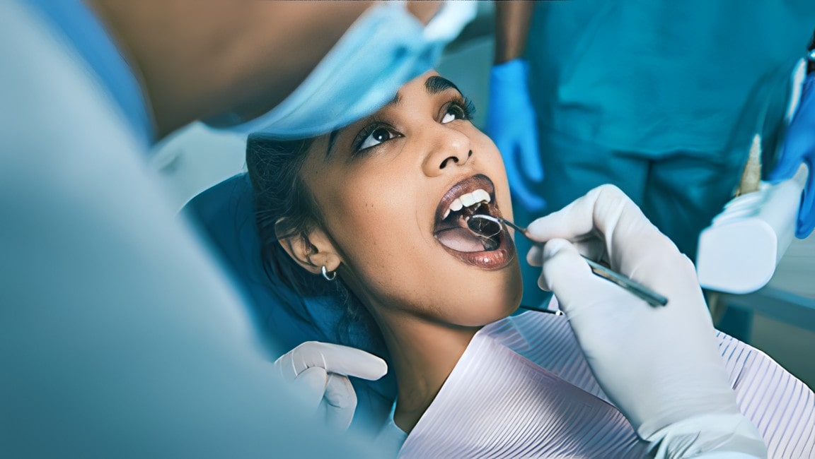 A young woman having dental work performed on her teeth.