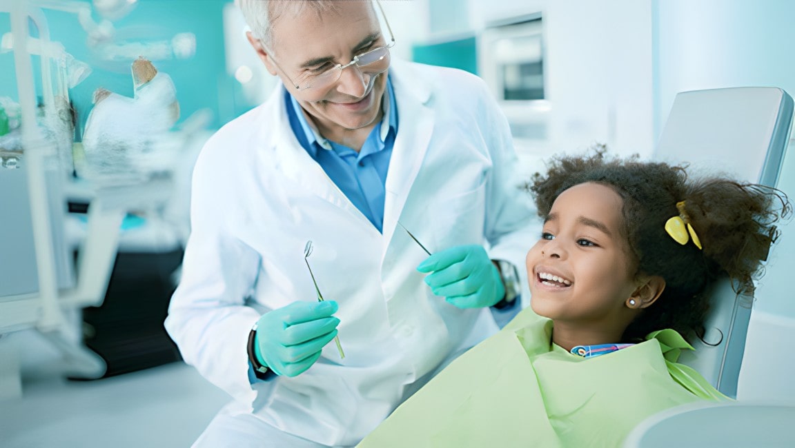 A happy young girl in in the dentist office, after a dentist has performed a dental sealant.